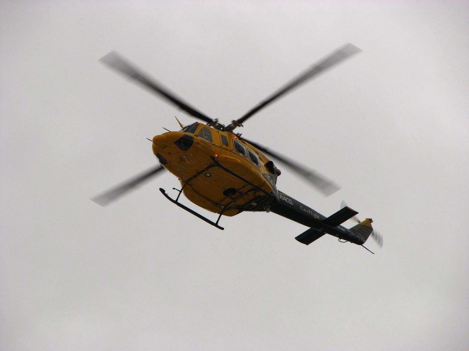 A Bell 412 rescue helicopter in flight — the twin-engine type, photographed in Australia.
