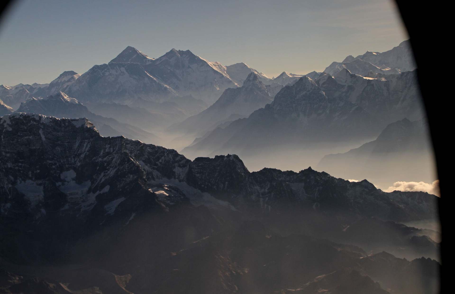 Everest, Lhotse and Nuptse from the cruise, framed by the window of the cabin the picture was taken from.