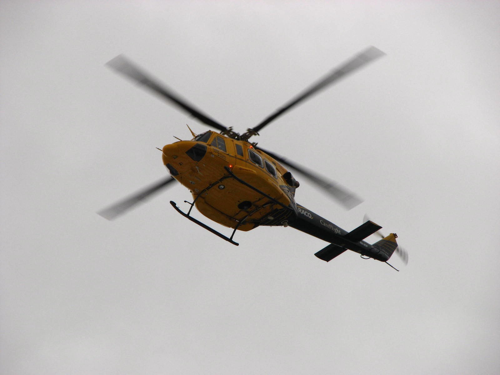 A Bell 412 rescue helicopter in flight — the twin-engine type, photographed in Australia.