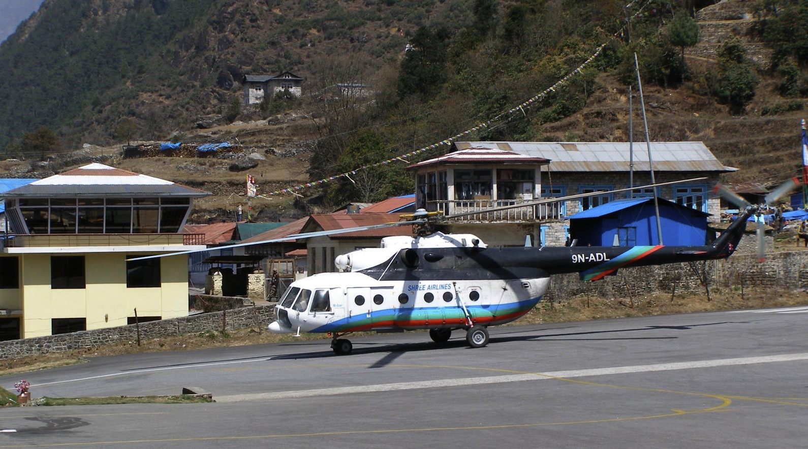 A chartered Mi-17 on the Lukla apron, loaded and turning for Syangboche.